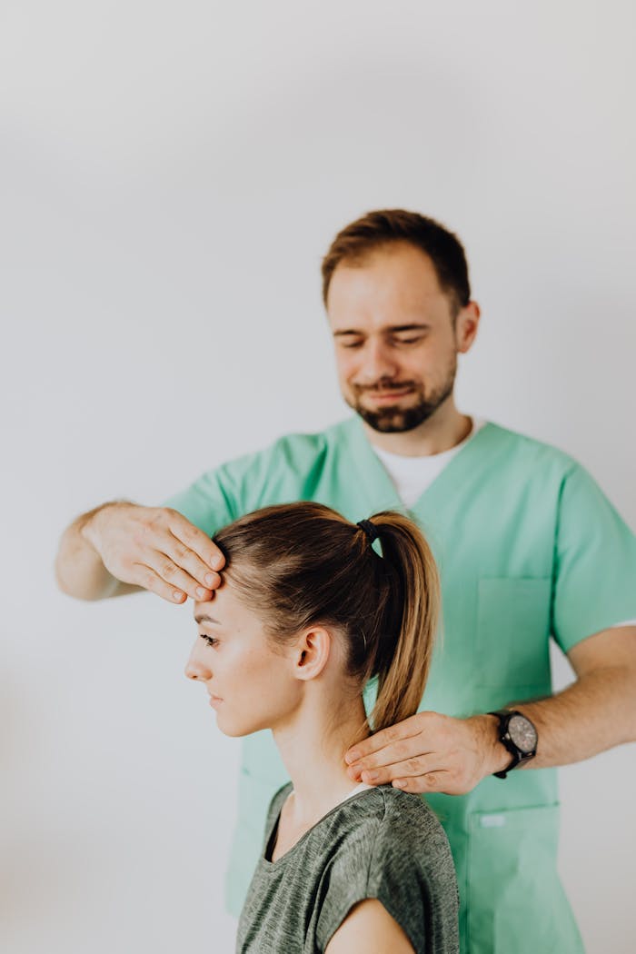 Chiropractor performing adjustment on female patients neck for pain relief.